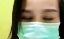 Playful Indonesian hottie wears a facemask while rubbing